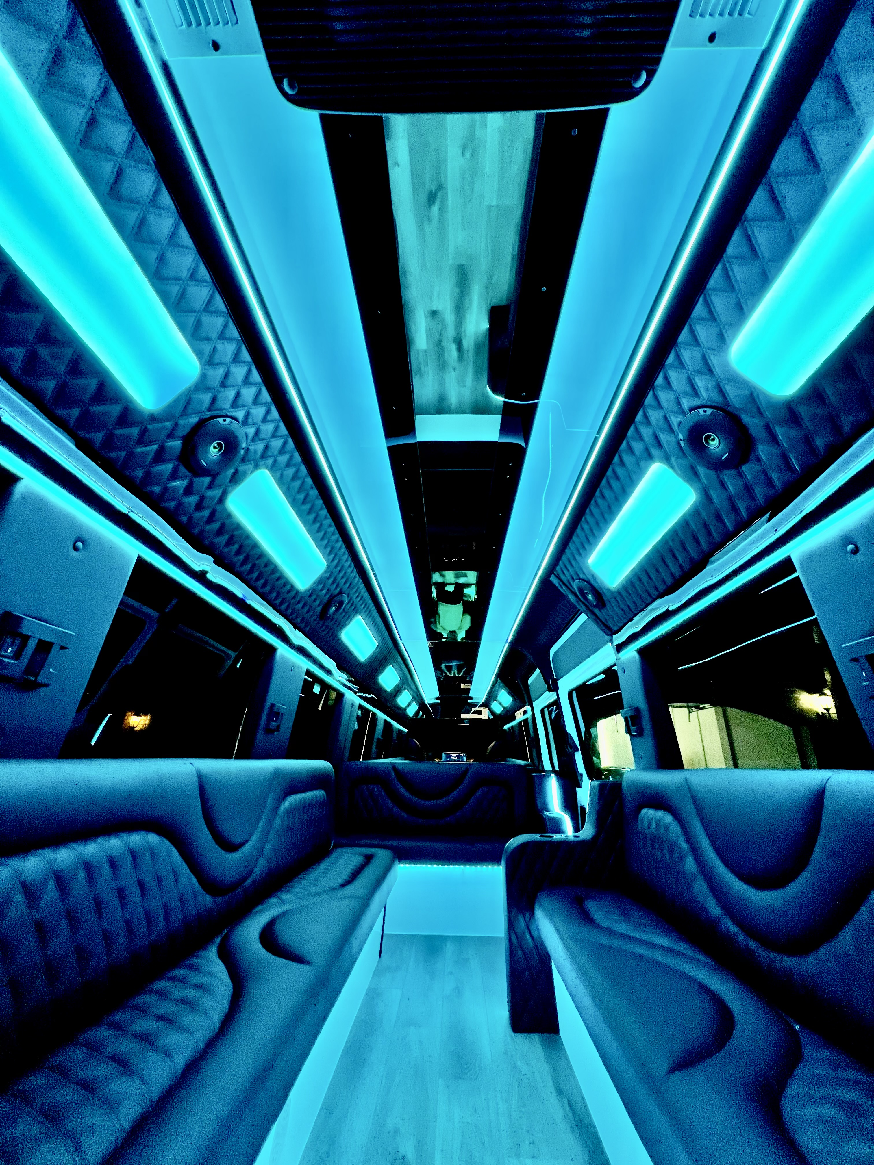 Luxury party bus interior with teal LED lighting